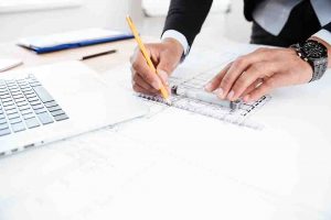 Close-up of businessman hands pointing pen to chart