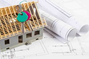 Electrical drawings, home keys and small house under construction, concept of building home