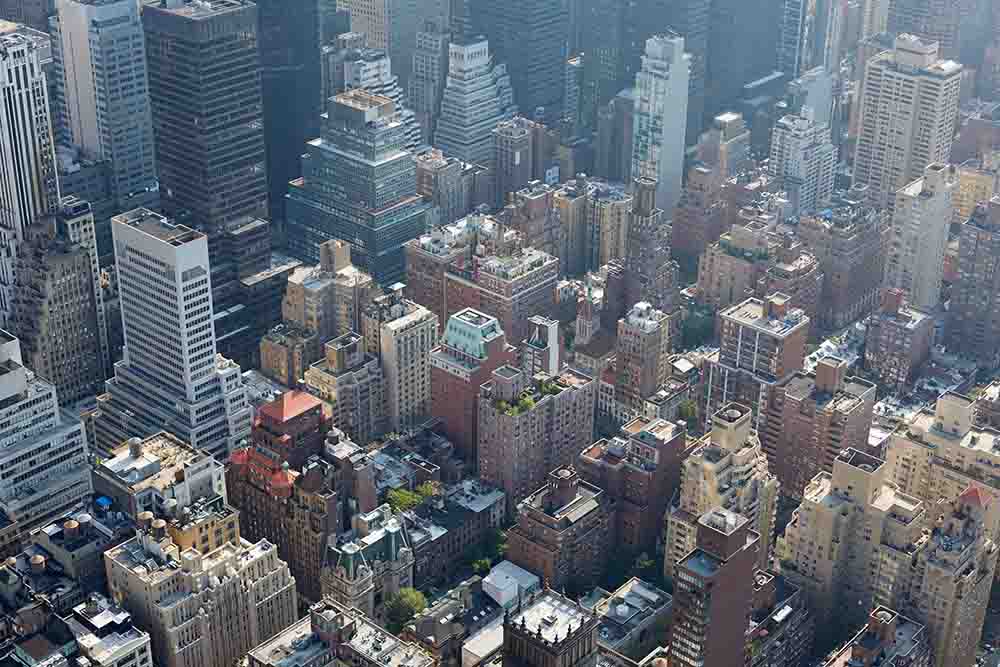 New York City aerial view with skyscrapers, sunlight and mist